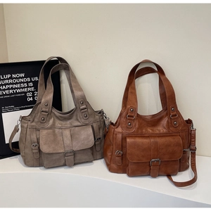 Macro shot of retro large capacity tote bags in grey and brown textured leather finish