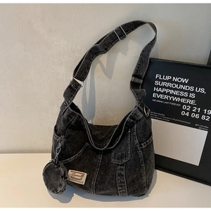 Close-up of vintage washed denim hobo bag with a matching mini round coin purse
