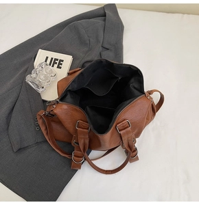 Top view of brown leather tote bag interior showing large capacity and black lining