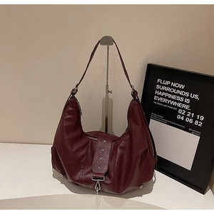 Detail of burgundy hobo bag with silver star rivets and premium matte leather texture