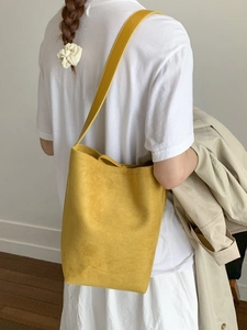 Fashionable bright yellow suede bucket bag with adjustable shoulder strap for women