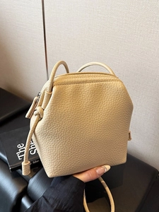 Minimalist beige lychee grain leather crossbody shell bag with geometric design