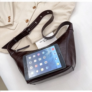 Macro view of dark brown hobo bag interior showing large capacity for a tablet device