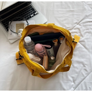 Top view of bright yellow nylon tote bag interior showing large storage capacity and items