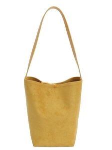 Minimalist yellow matte bucket bag with adjustable shoulder strap and spacious interior