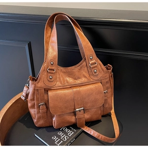Detailed view of brown retro textured PU leather handbag with adjustable shoulder straps