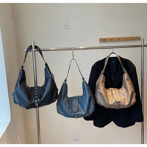 Detailed view of three vintage soft leather hobo bags with star rivets and buckles