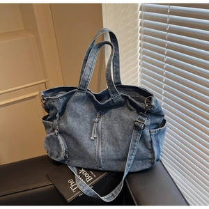 Detail of blue denim tote bag texture with side pocket and round mini coin purse