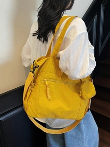 Large bright yellow nylon tote bag with small round pouch and wide shoulder strap