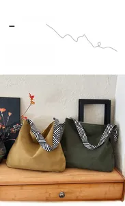 Detail of corduroy hobo bags in yellow and olive green with geometric patterned straps