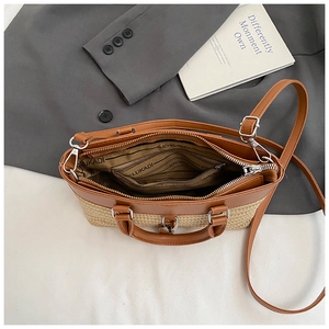 Minimalist bucket bag in brown leather and woven fabric with an adjustable shoulder strap