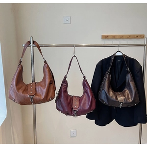 Detail view of large tote bags with star rivets in brown, burgundy, and coffee colors
