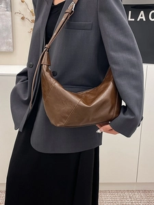 Brown vintage crescent dumpling bag in premium leather with adjustable shoulder strap