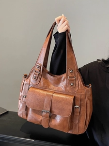 Retro brown leather tote bag for women featuring front flap pockets and silver hardware