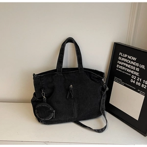 Detail of black washed denim tote bag with long strap and matching mini coin purse