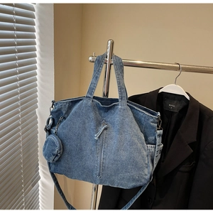 Detailed shot of retro washed denim tote bag with functional zipper and round coin purse