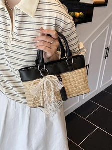 Elegant woven straw tote bag with black leather patchwork and pearl lace bow charm