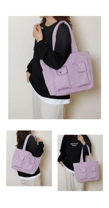 Detail of purple padded puffer tote bag with spacious outer pockets and soft shoulder strap