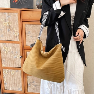 Large mustard yellow corduroy tote bag with striped shoulder strap for casual daily use