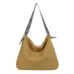 Minimalist striped canvas tote bag with black and white geometric patterned knot straps