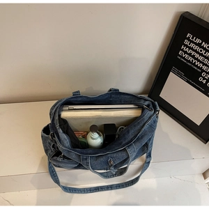 Top view of large capacity denim tote bag showing spacious interior with laptop and books