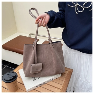 Detail of vintage matte large tote bag with matching mini pouch and slim shoulder straps