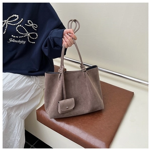 Detail of vintage matte brown tote bag with matching mini pendant pouch for women