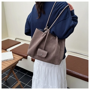 Detail of vintage matte brown tote bag with decorative knots and matching mini pouch
