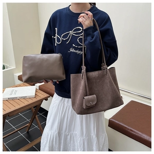 Detail of vintage matte brown tote bag set with knotted strap and matching pouch