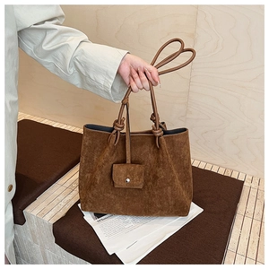 Detail view of large dark brown frosted suede tote bag with a matching small hanging pouch