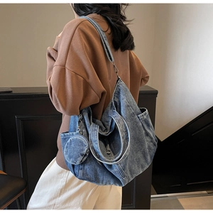 Detail of blue denim tote bag with matching round coin purse and adjustable strap