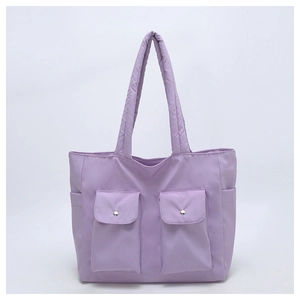 Close-up of light purple nylon tote bag featuring front flap pockets and silver metal buckles