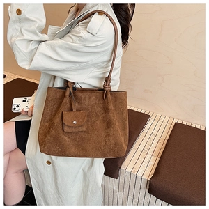 Brown suede tote bag detail with matching coin purse and stylish knot shoulder strap detail