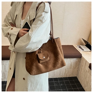 Detail of vintage matte suede tote bag with matching mini pouch and knotted straps