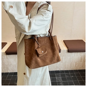 Detail of vintage matte brown tote bag with suede texture and mini matching pouch
