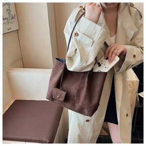 Close-up of large brown matte tote bag with small matching purse attachment