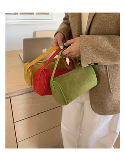 Detailed macro view of three colorful matte suede cylinder handbags in yellow, red and green
