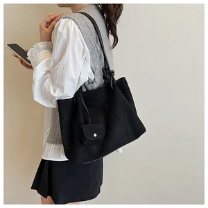 Detail of black matte suede tote bag with matching small coin purse and knot strap