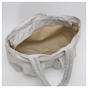 Interior view of large quilted tote bag with zippered pocket and spacious storage