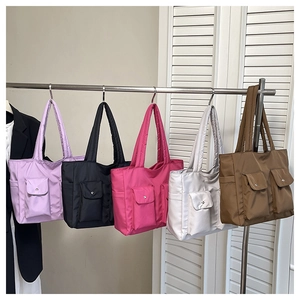 Row of quilted canvas tote bags in purple, black, pink, silver, and brown colors