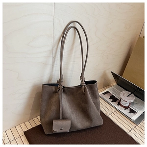 Detail view of dark brown frosted tote bag showing soft suede texture and mini pouch