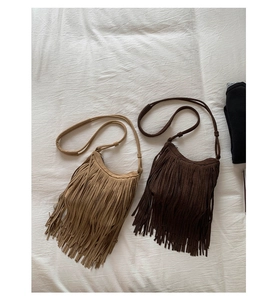 Flat lay of retro Bohemian tassel crossbody bags in light tan and dark brown finishes