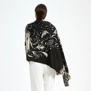 Detail of classic black shawl featuring cream white feather and meteor patterns