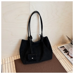 Detail of black matte suede tote bag with a small matching purse and knotted strap accents