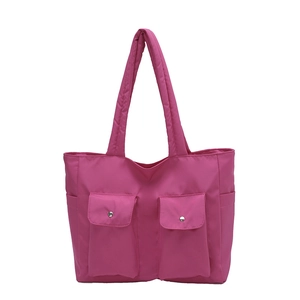Large magenta nylon tote bag with dual front pockets for stylish commuting and casual use