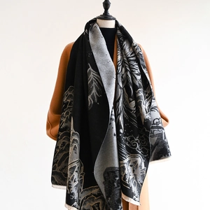 Detail of cashmere-like scarf showing Chinese style mountain patterns and fringe edges
