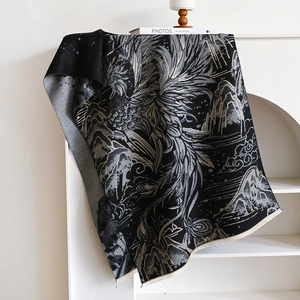 Detailed jacquard pattern of mountains and clouds on a thick black and white shawl with fringe