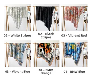Detail view of various herringbone silk scarves with luxury hand-rolled edges and patterns