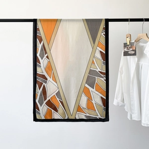 Detail of herringbone pattern silk scarf with geometric color block and fine stitching