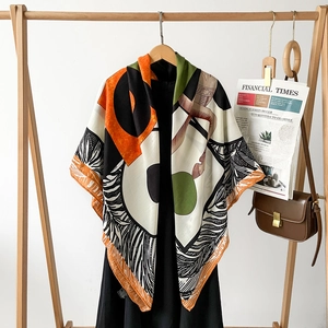 Close-up of luxury silk scarf with geometric patterns and hand-rolled edges on a dress